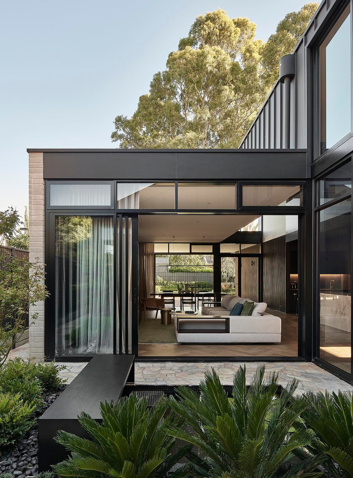 Glazed living spaces open towards the rear garden.