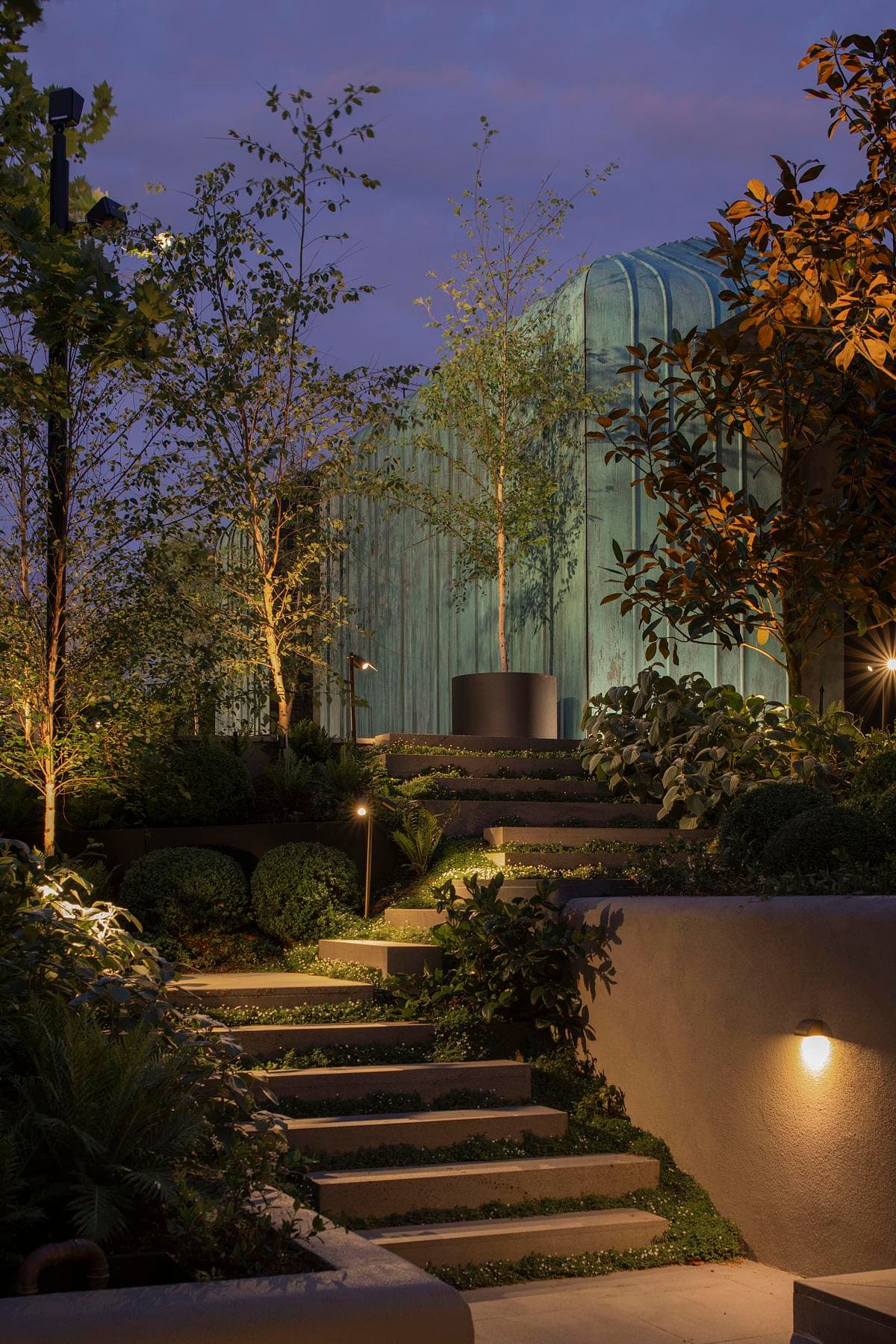 Garden steps lead through planting towards the copper-clad wing.