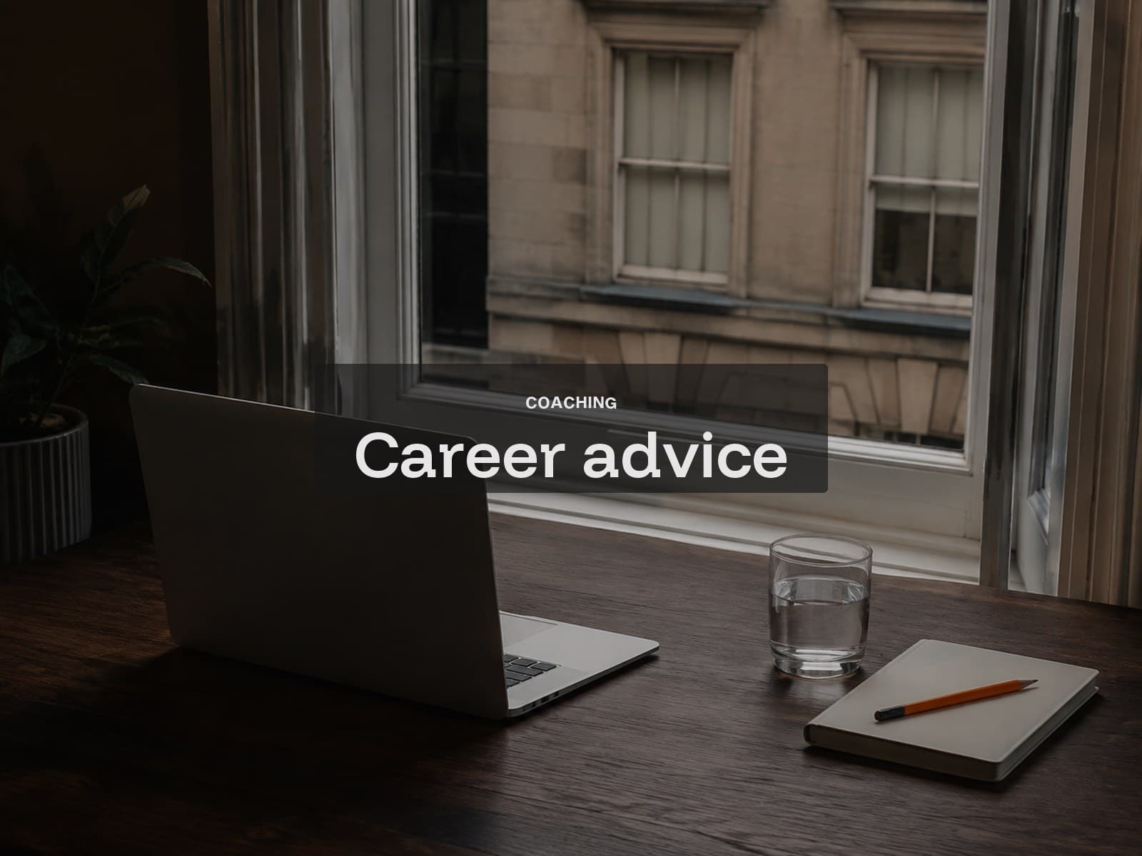 Career advice call cover: a closed laptop, water glass and notebook beside a sash window.