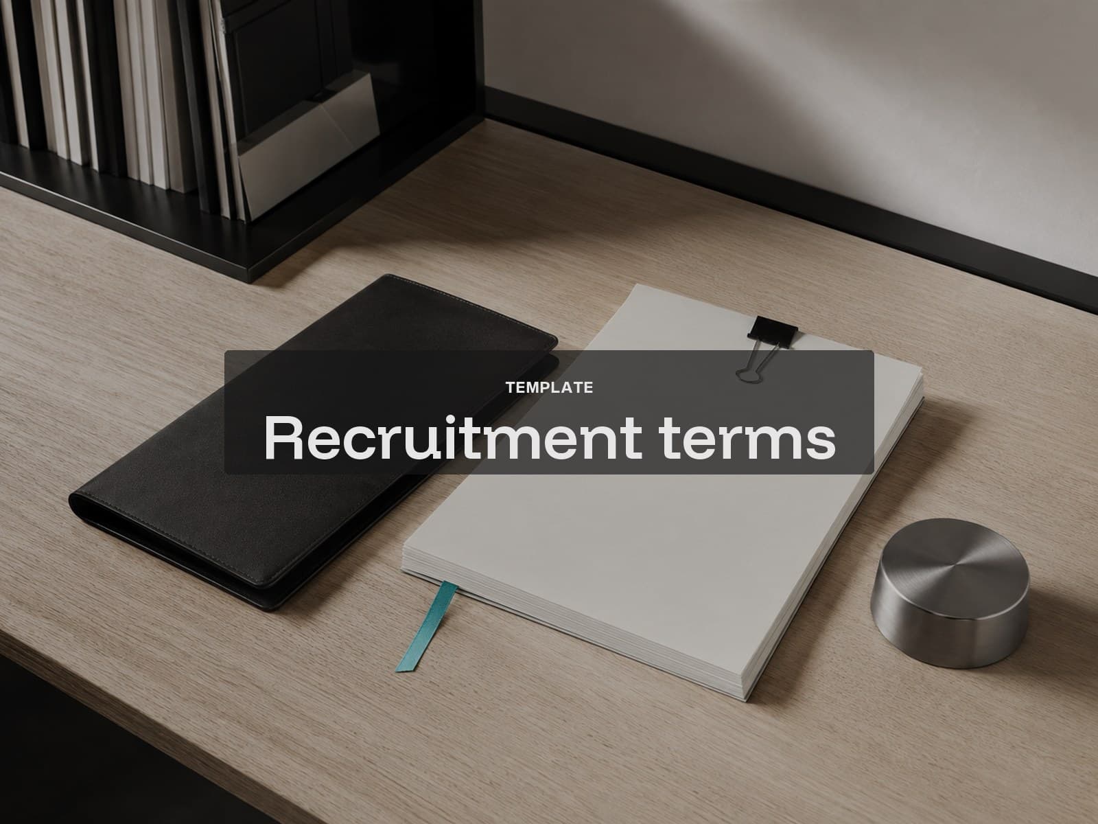 Recruitment terms template cover: a black folio, clipped paper pack and steel paperweight.