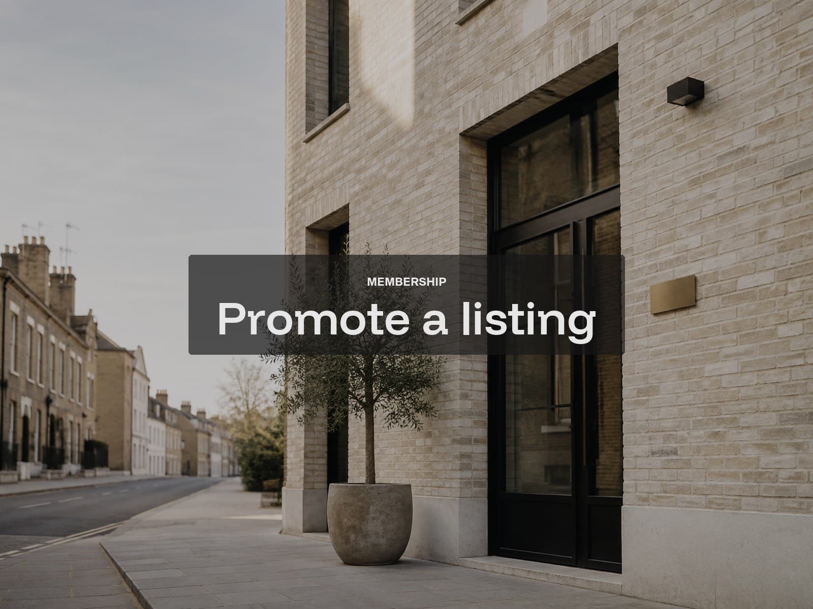Promote a listing cover: a pale-brick practice facade with a black steel door and olive tree.