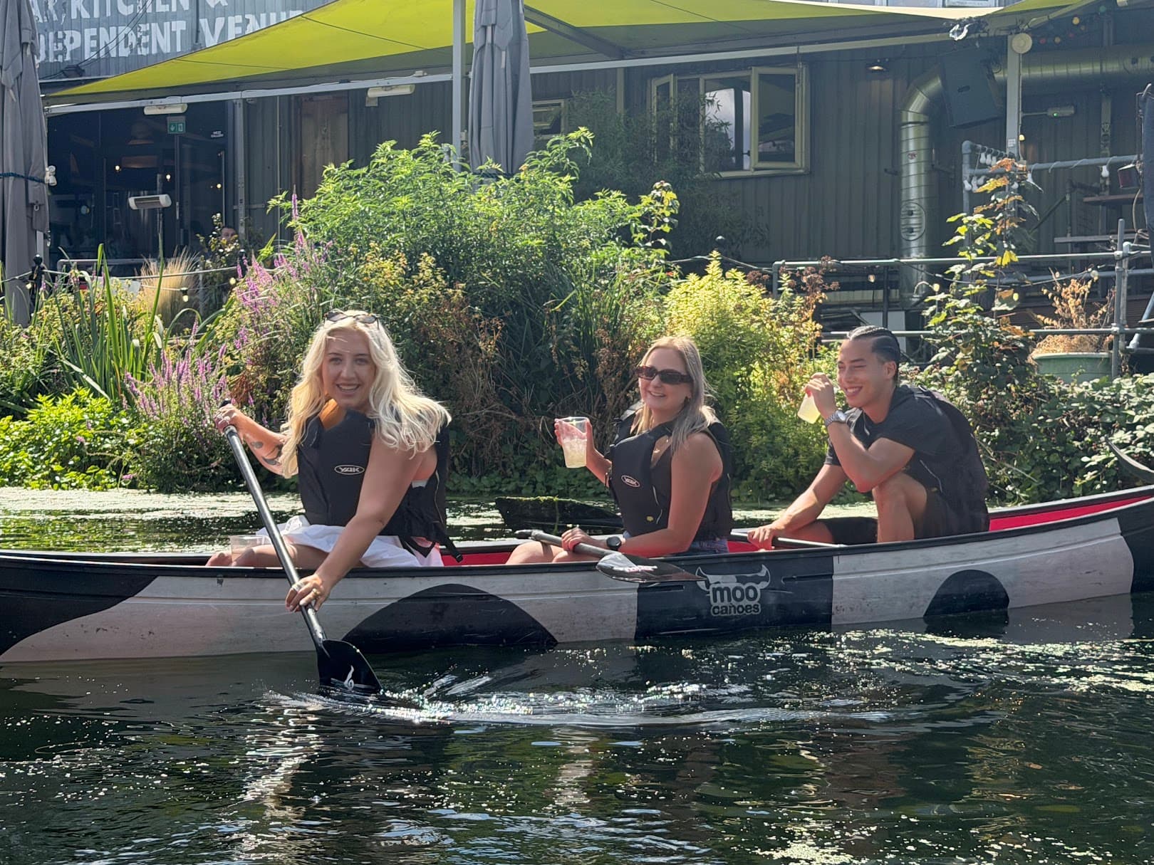 Three Architecture Social colleagues smiling together in a canoe on the canal