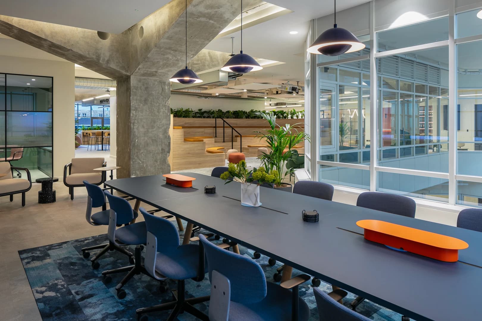 Shared work table, pendant lights and planting at DF Capital