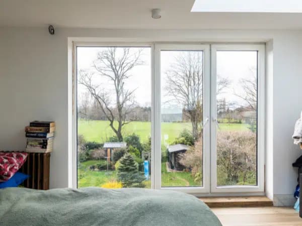 Bedroom window framing the trees and green space of Longford Park