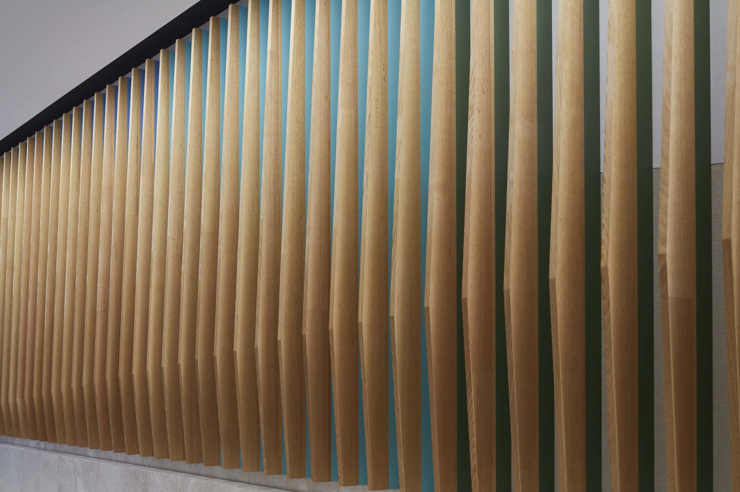 Closely spaced vertical timber fins forming an undulating interior wall.