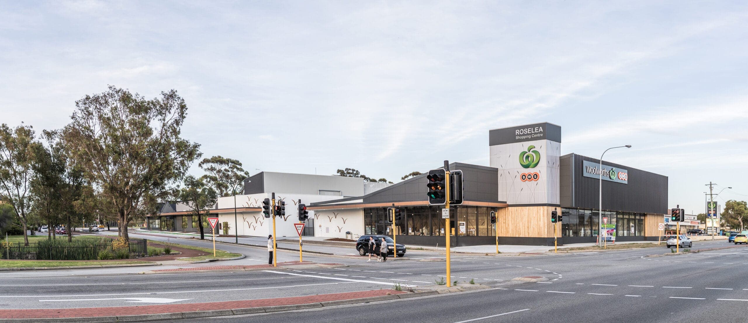 Roselea Shopping Centre viewed across the street, with a glazed frontage and the centre's entrance sign.