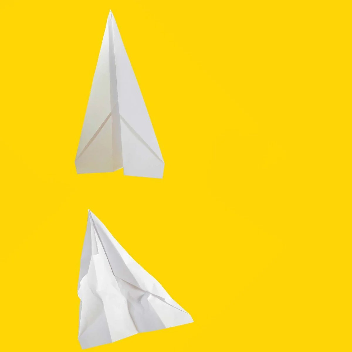 Stages of a paper airplane: from pristine to deformed to crumpled.