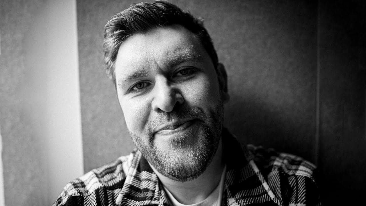 Timeless black and white portrait of a friendly man with a warm smile.