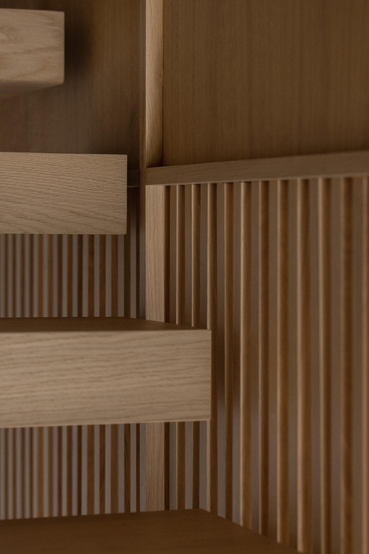 Oak battens and stair treads meet in a carefully detailed junction.