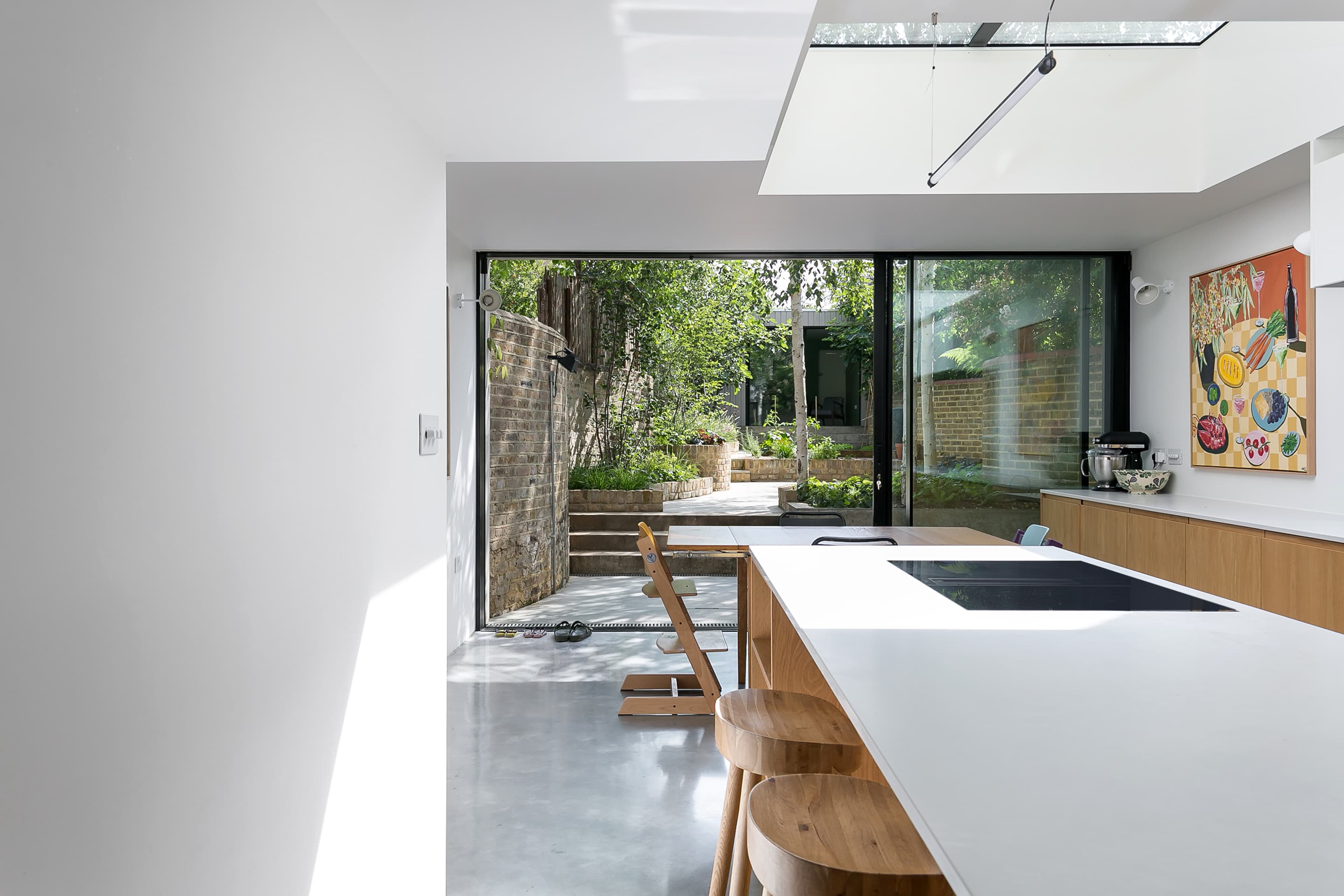 A broad rooflight lights the kitchen and its view into the courtyard.