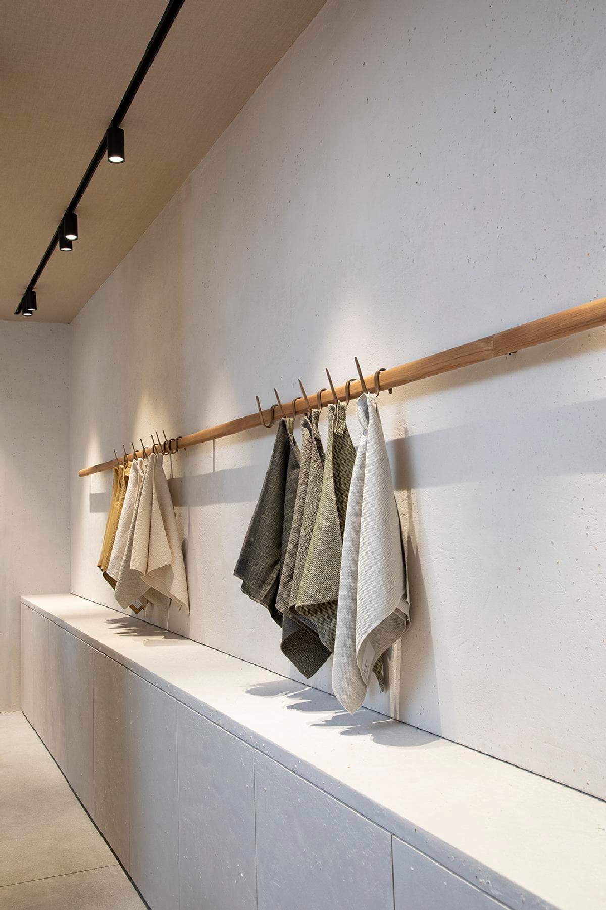 Hanging material samples reveal the showroom’s palette of colours and textures.