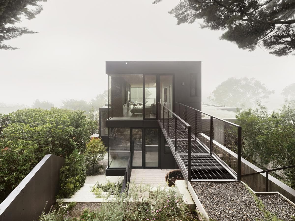 A steel bridge connects the new family room with the hillside.