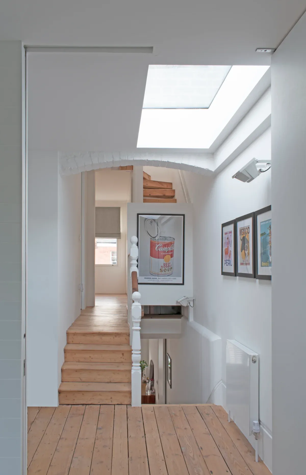 The upper landing opens towards a large rooflight.