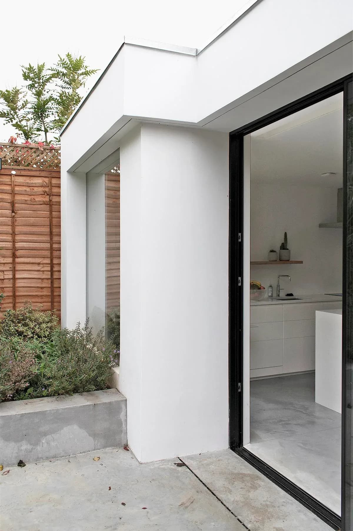 Glazing separates the white planes of the rear extension.