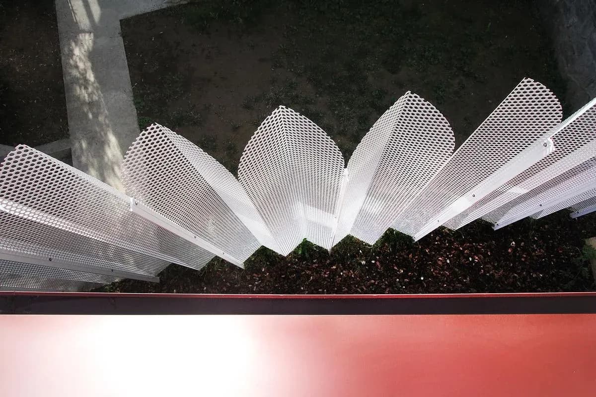 The folded screen creates a patterned edge above the garden.