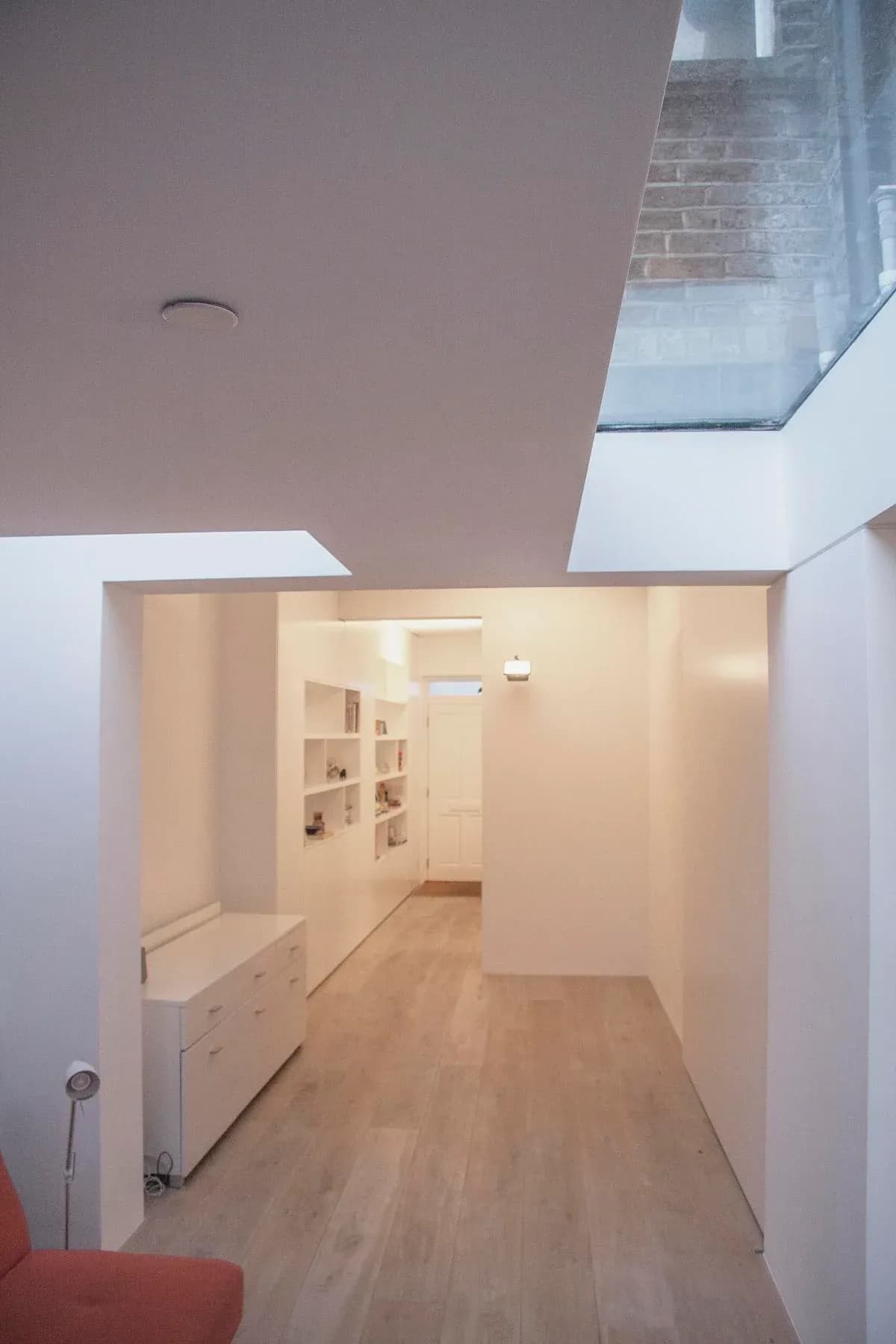 A long rooflight brings daylight into the linked living spaces.