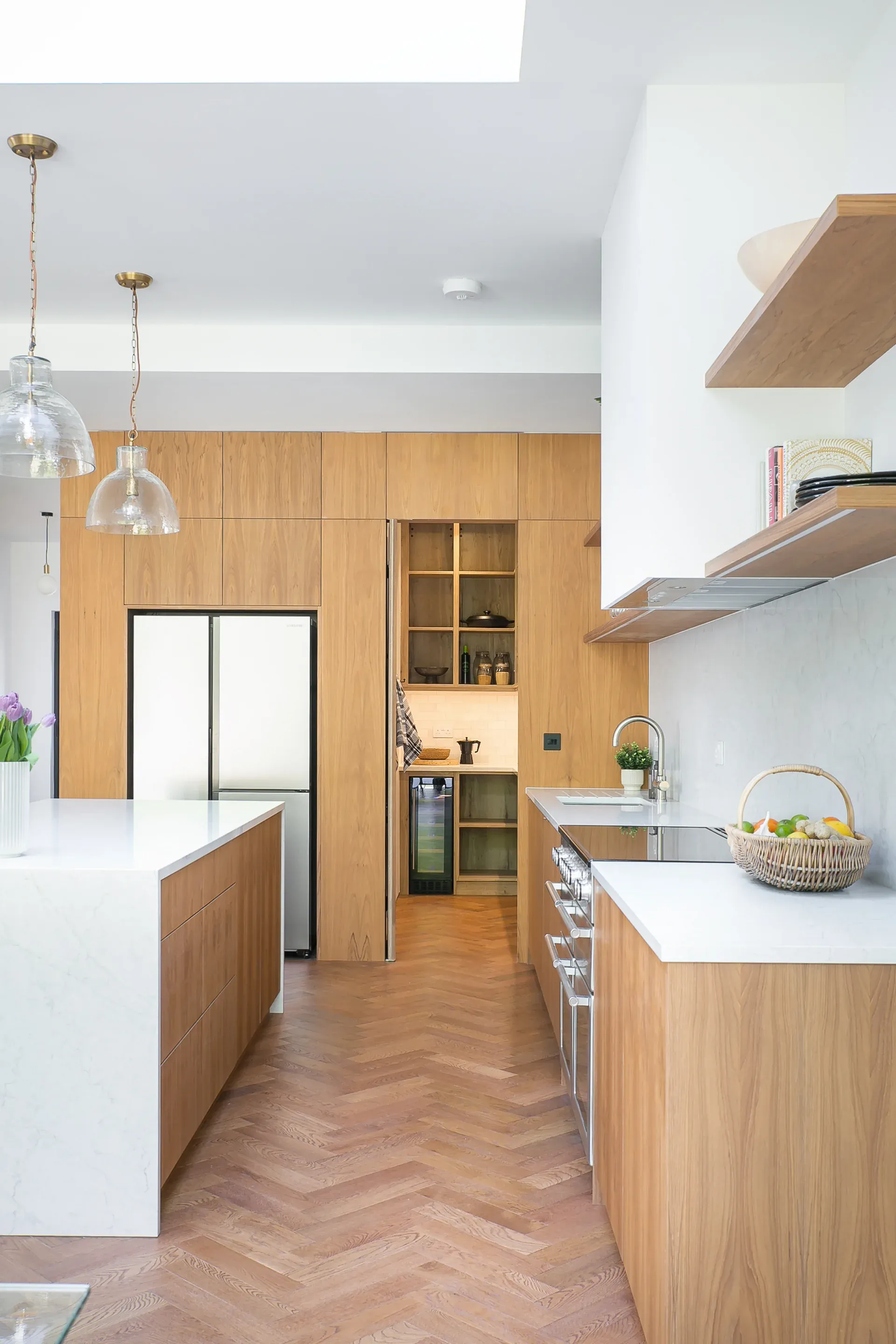 A large rooflight brings daylight above the kitchen island and timber joinery.