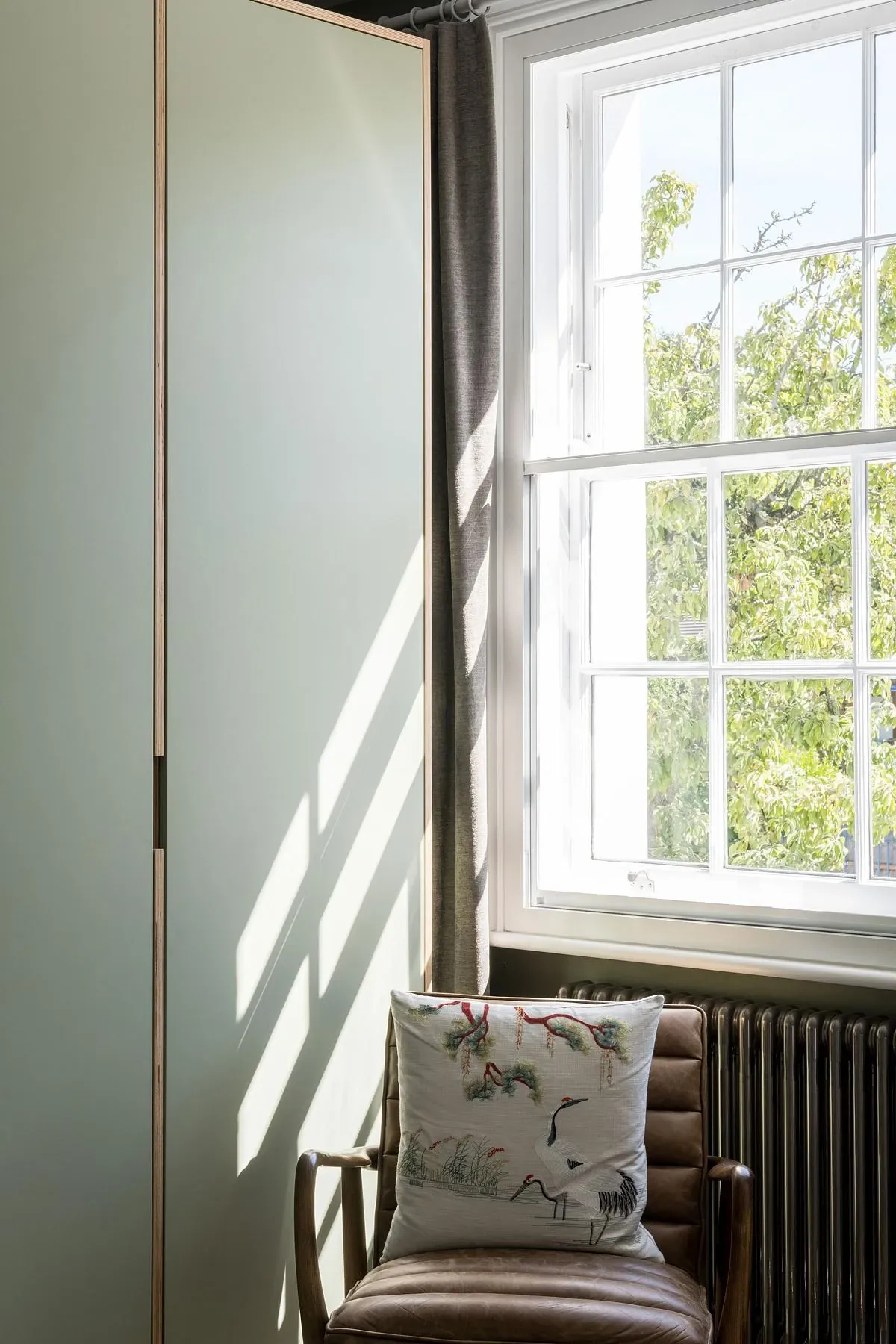 Pale green joinery and a sash window in one of the upper rooms.