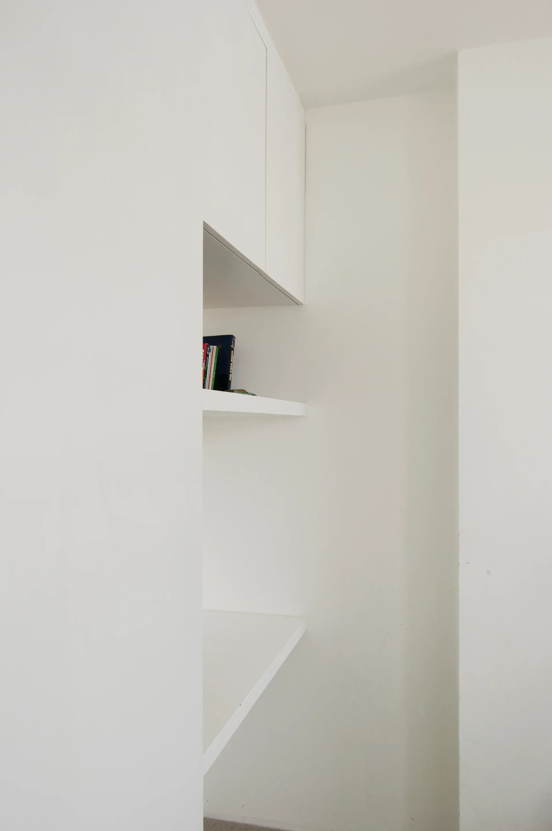 A white opening frames the stair and the adjoining rooms.