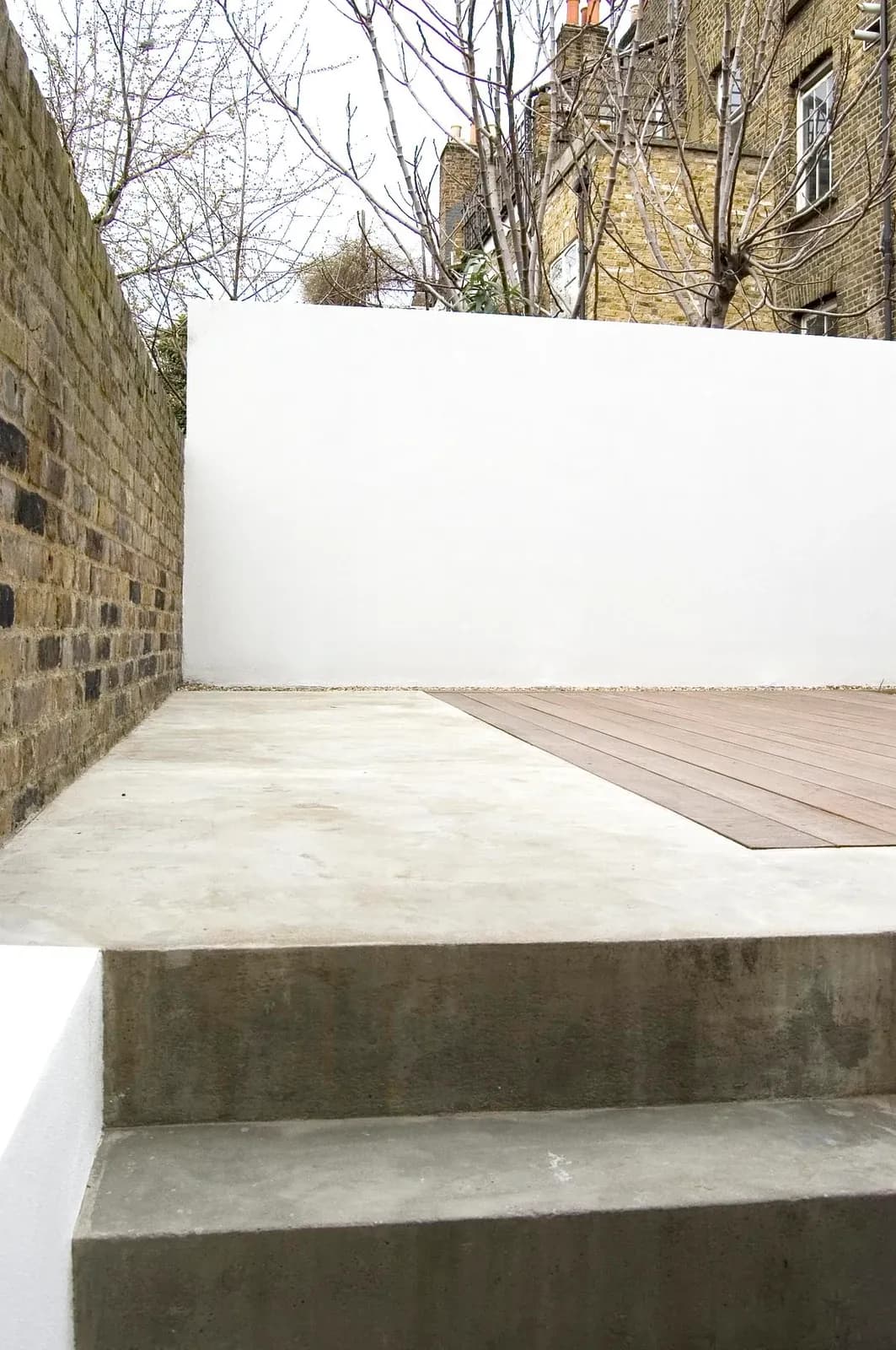 Paved garden space extends the concrete material palette at Periscope.