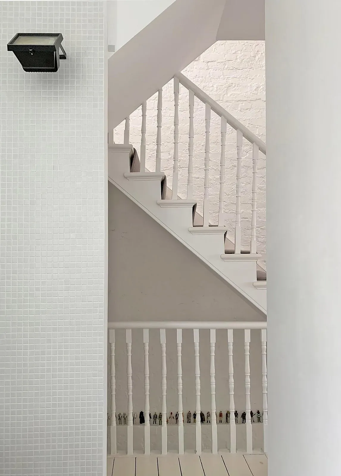 An original balustrade meets white-tiled walls and timber elements at Diorama 2.