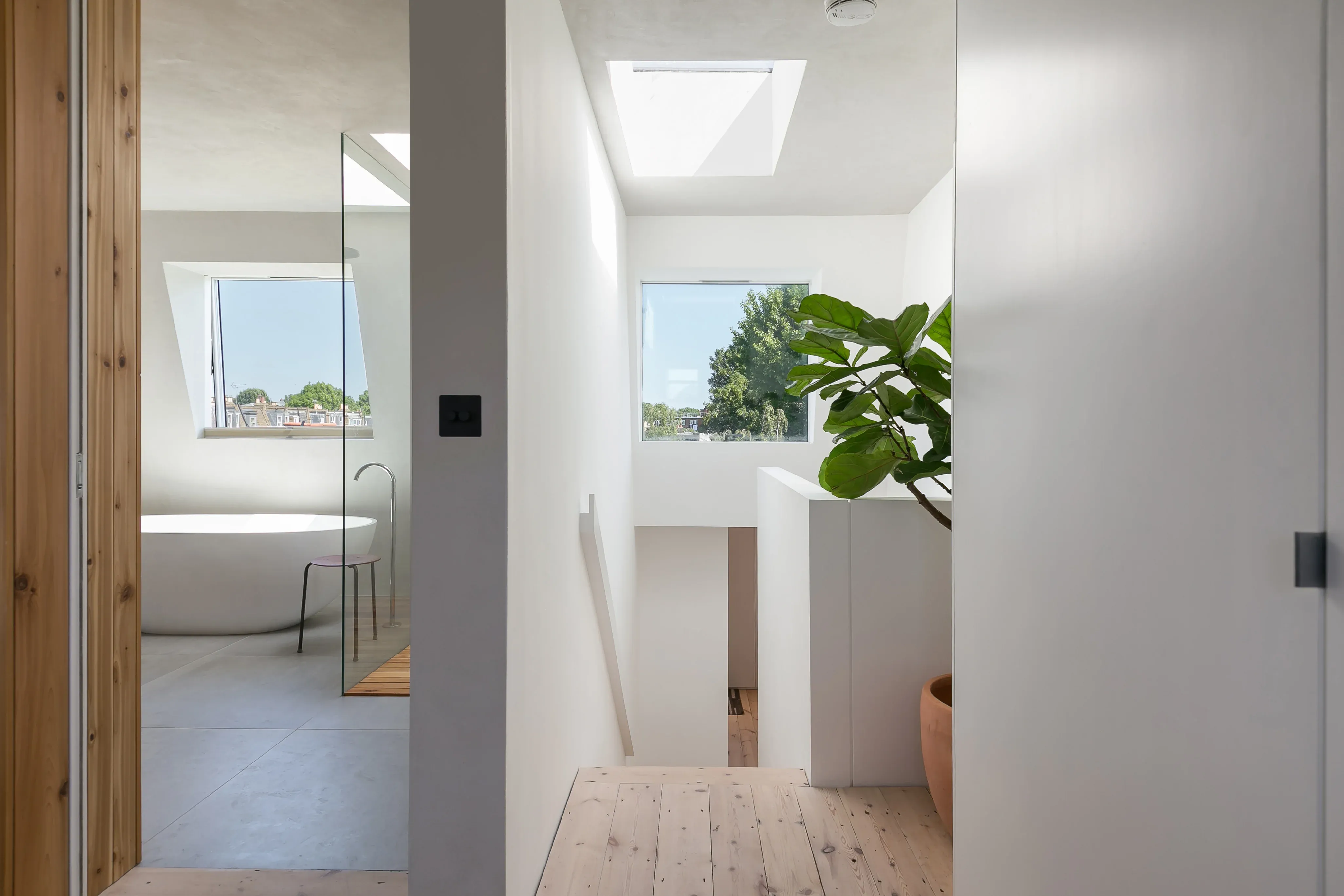 Frameless doorways connect the upper bedroom and bathroom.