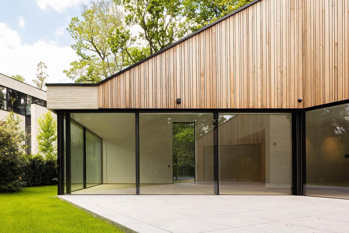 Timber cladding folds around the glazed garden corner.