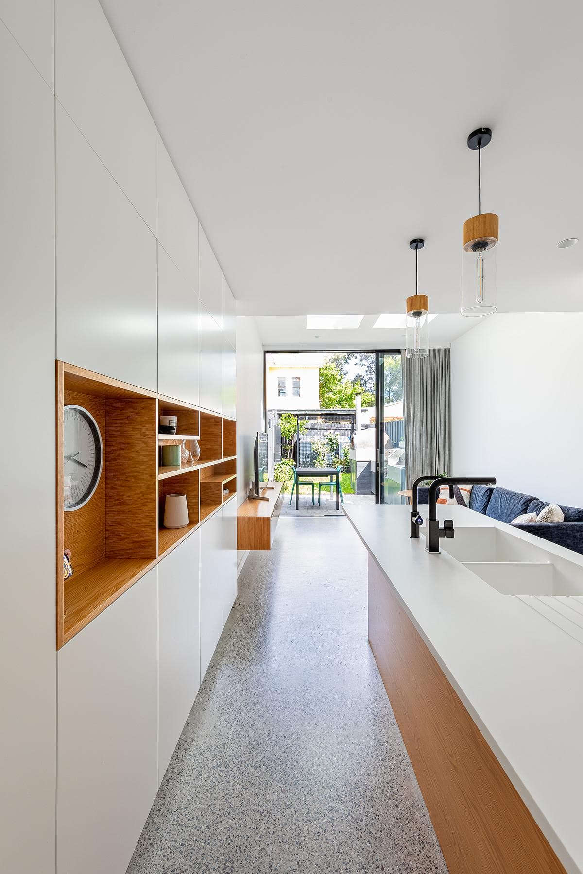 A long kitchen looks through to the rear outdoor space.