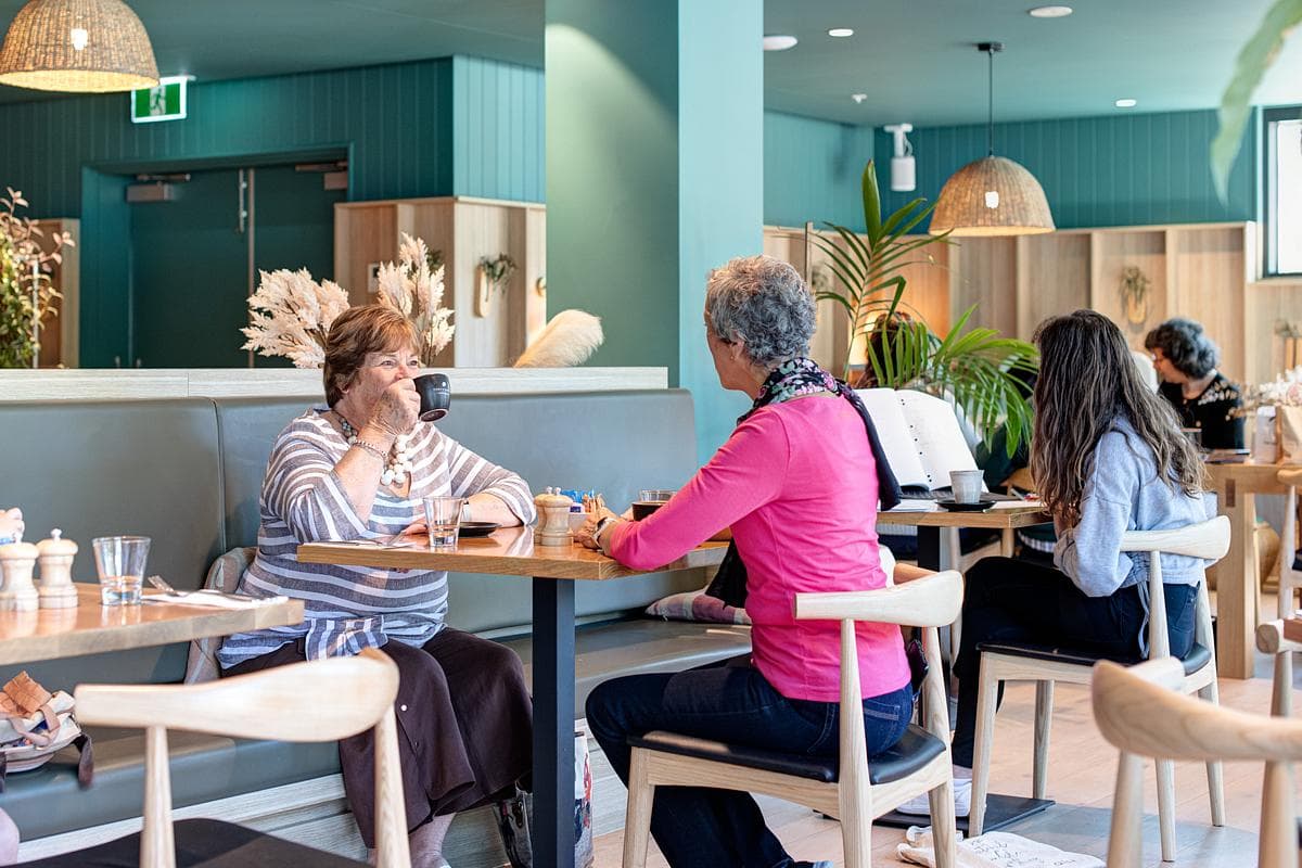 The café provides a setting for conversation and everyday social contact.