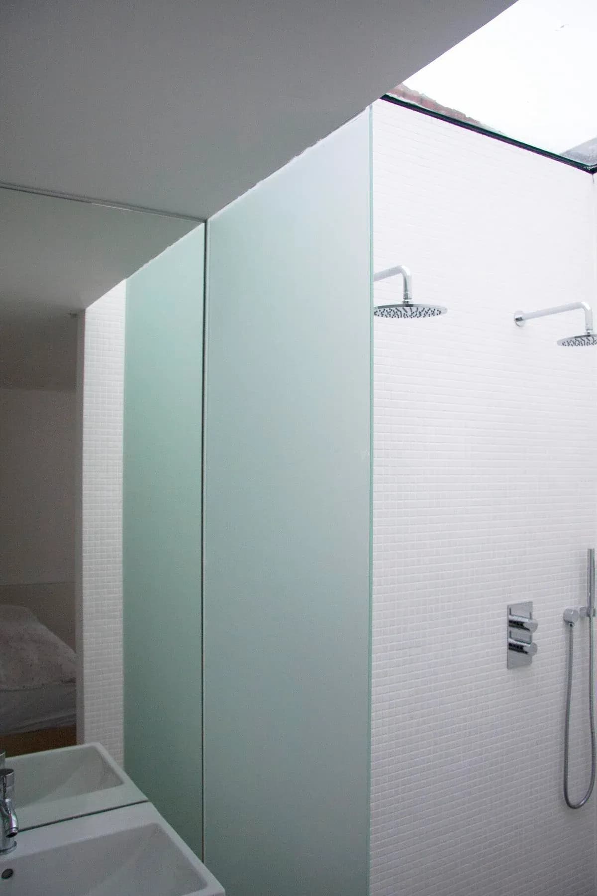 A glazed roof admits daylight above the tiled shower room.