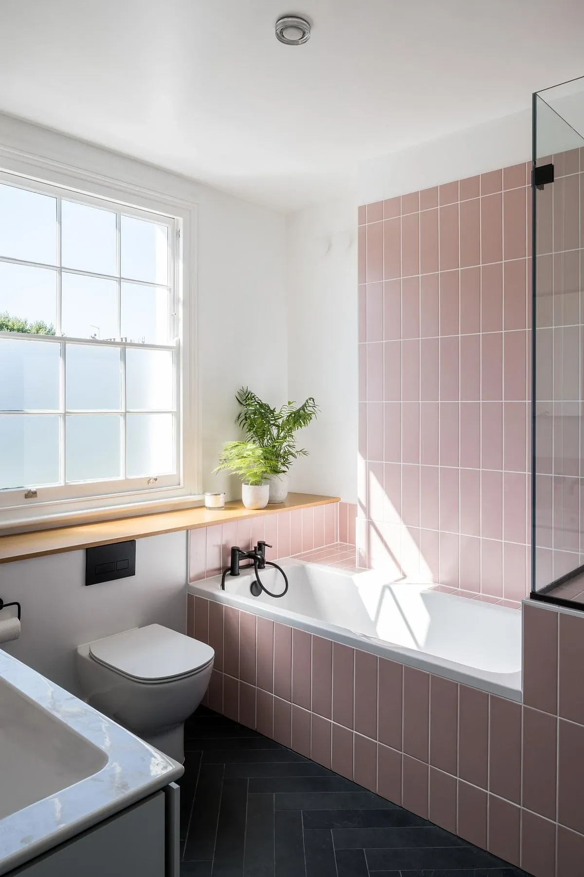 Pink tiles line the top-floor bathroom.