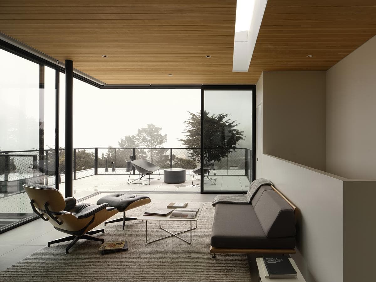The upper family room opens towards the distant view.