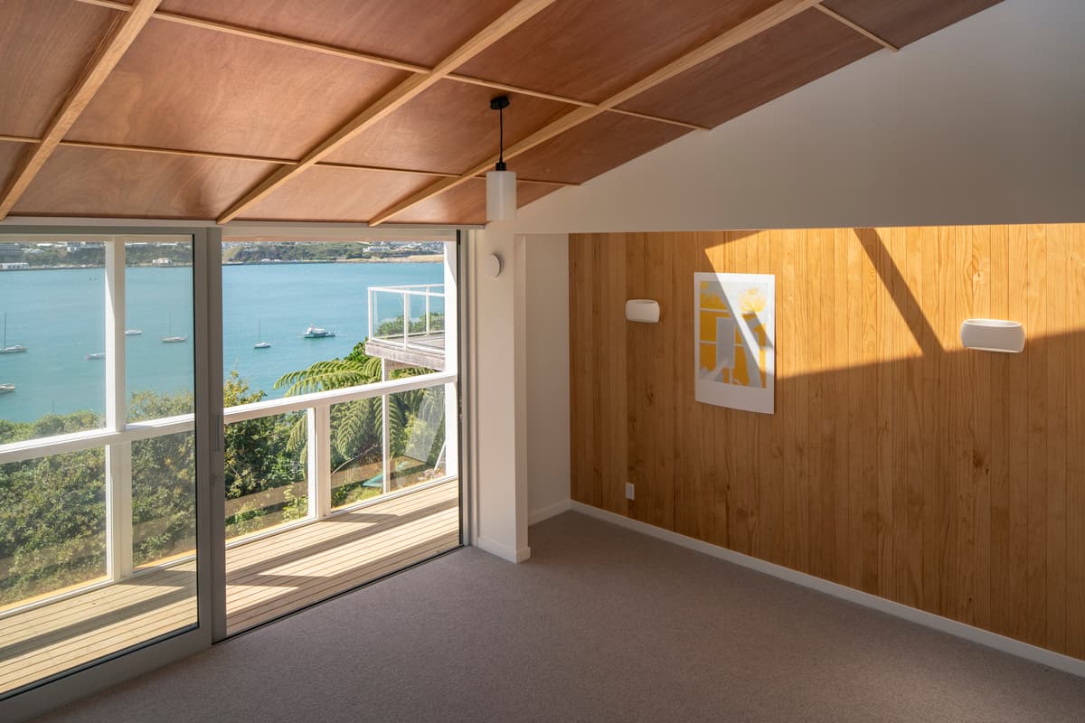 A long skylight lights a plywood-lined alcove overlooking the harbour.