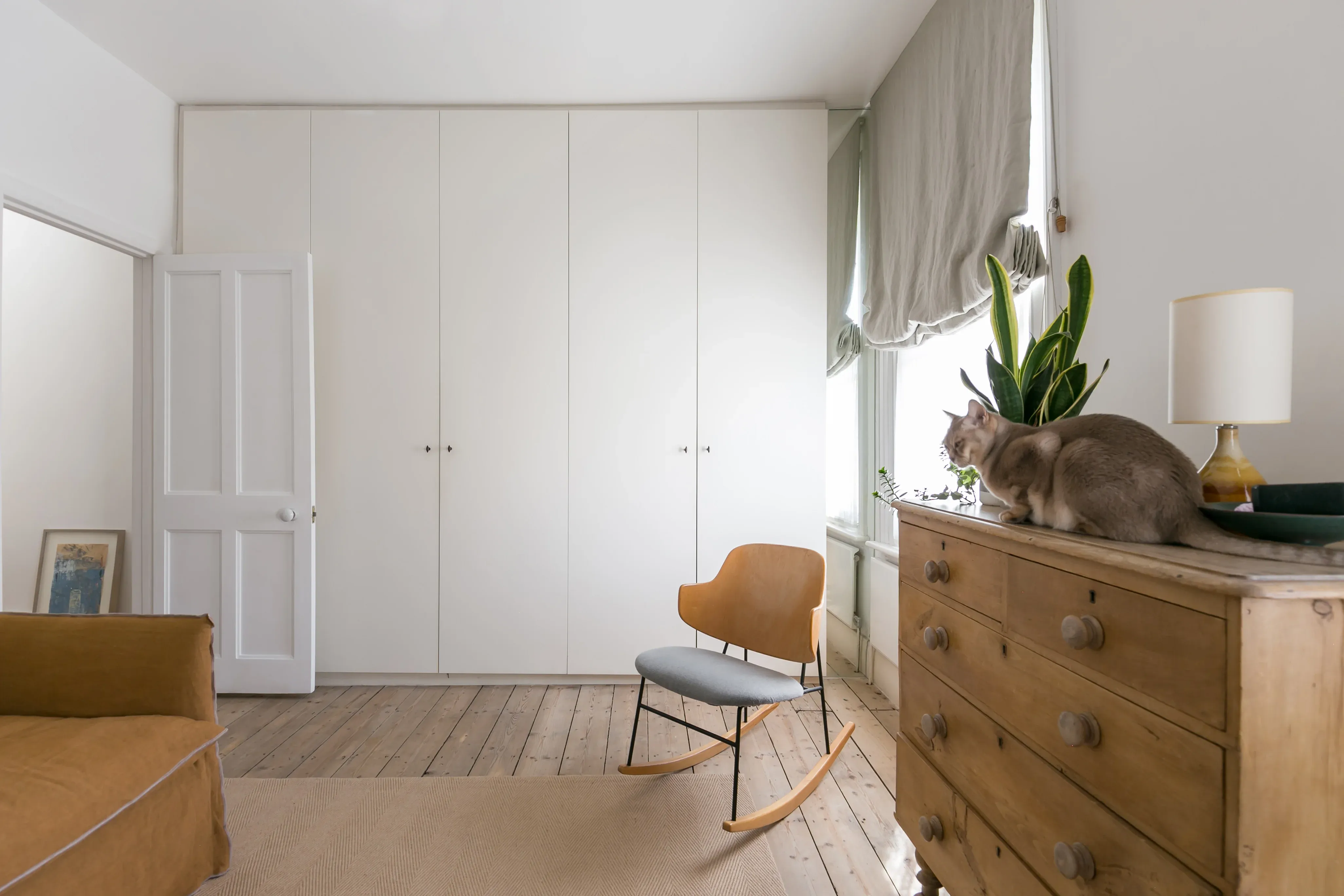 Built-in storage gives the bedroom a clear, continuous wall.