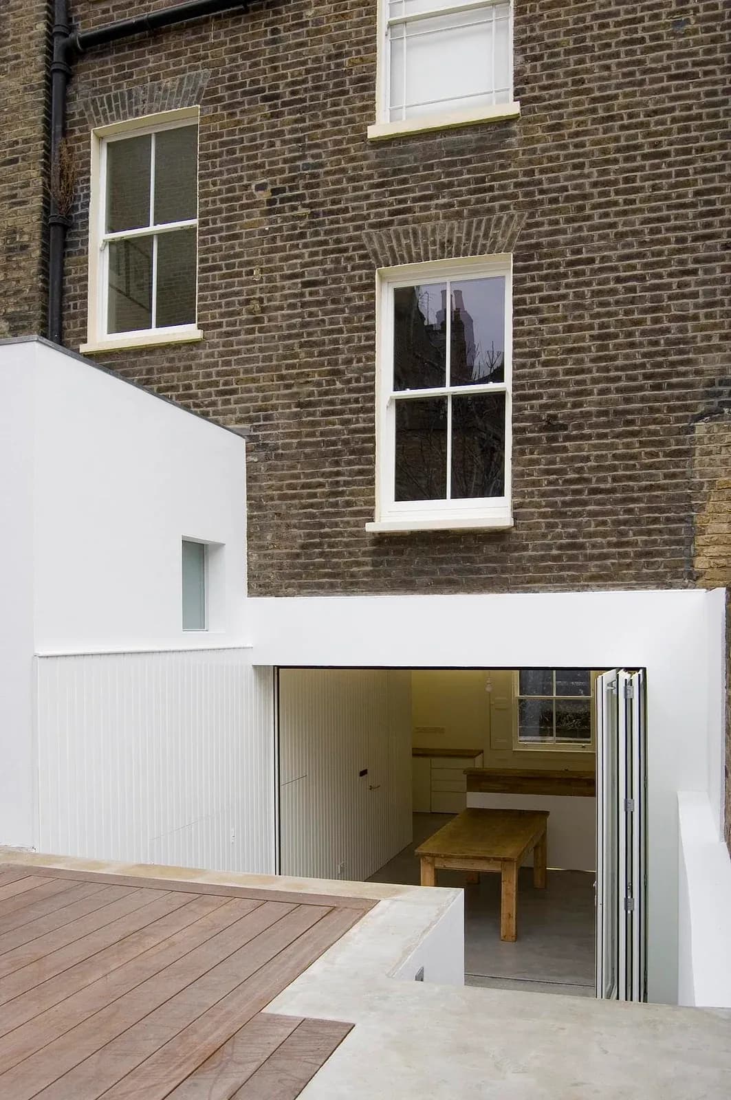 The white rear addition meets the Victorian brick house at Periscope.