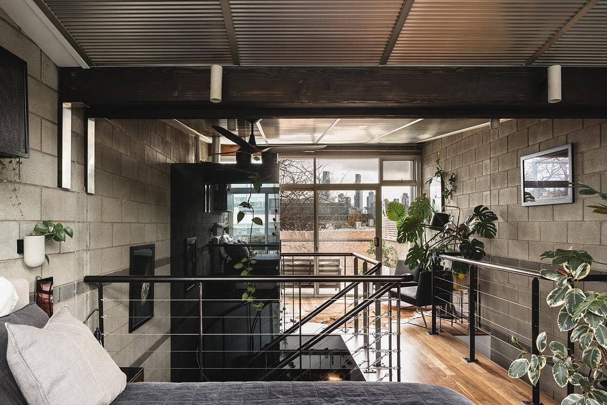 The upper room overlooks the stair and light-filled glazing.
