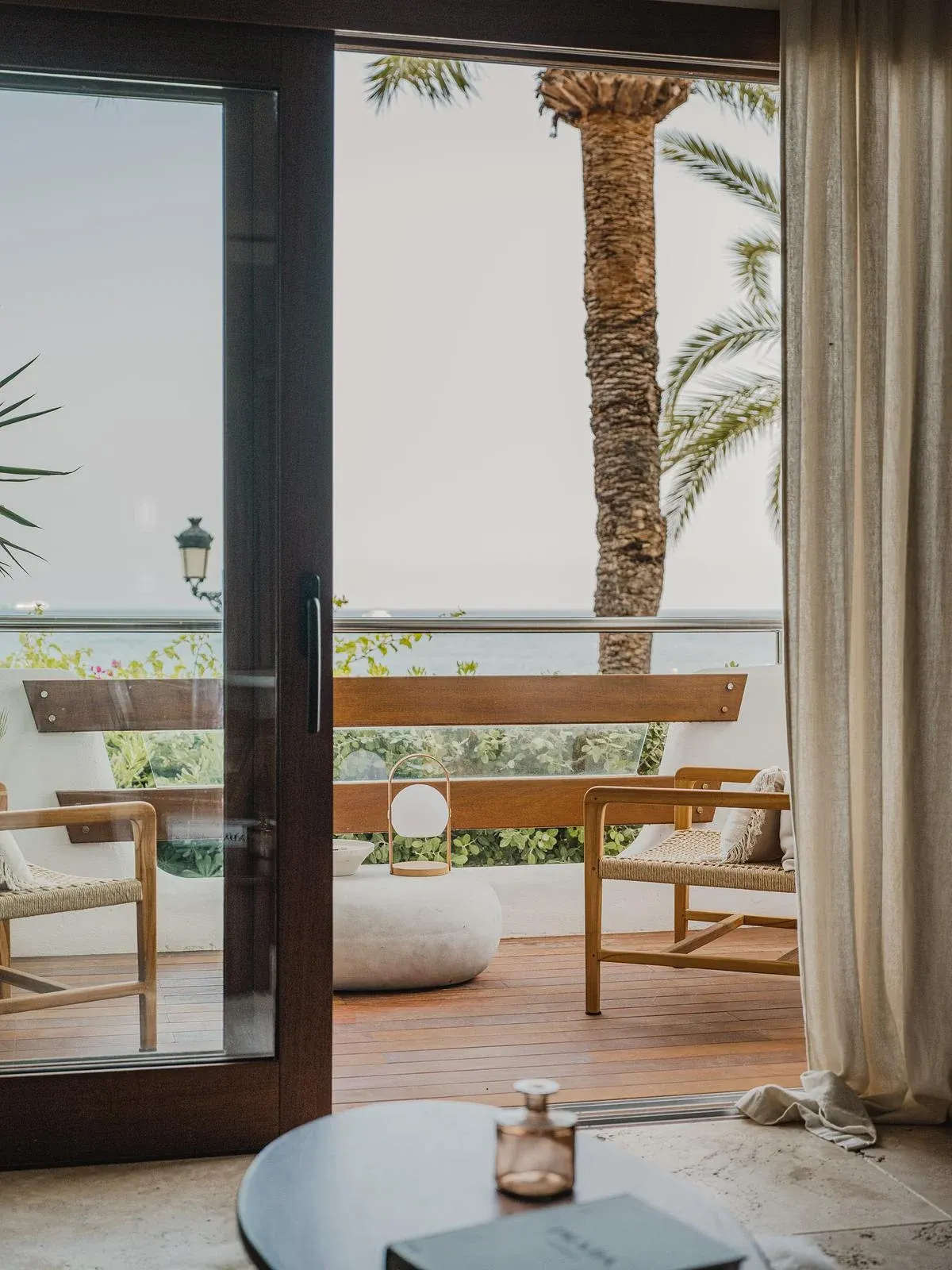 Glazed doors connect the living space with the seafront balcony.