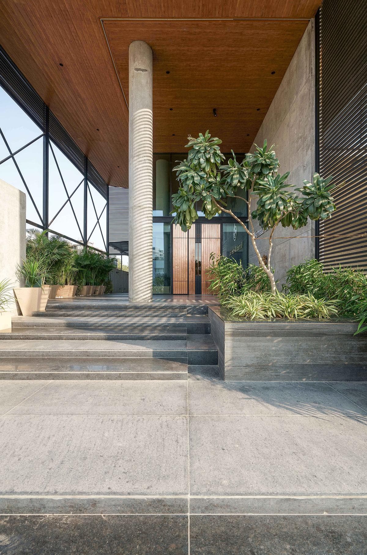 Steps lead into the covered entrance.