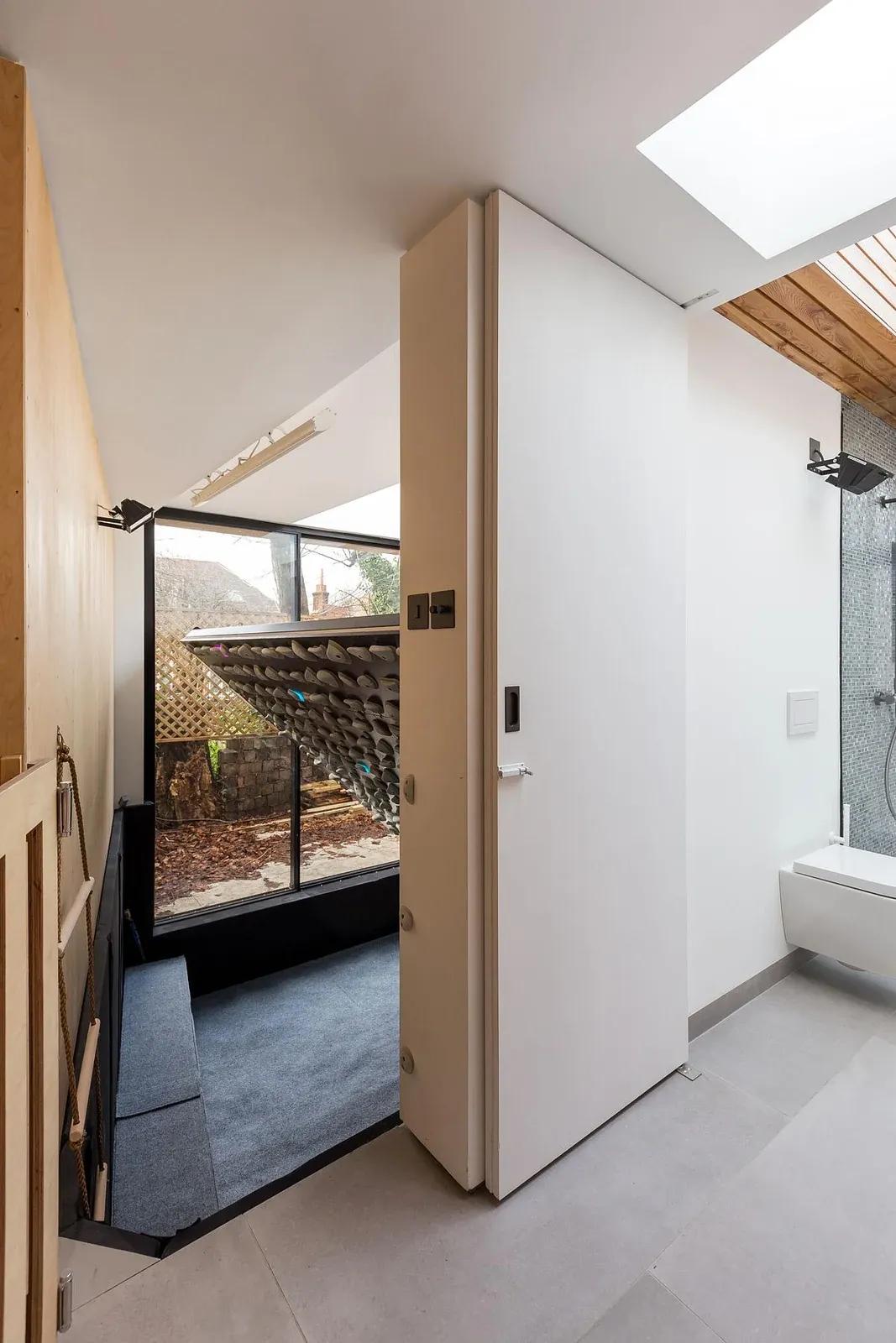Roof-lit shower room linking the office and climbing space at Split Space.