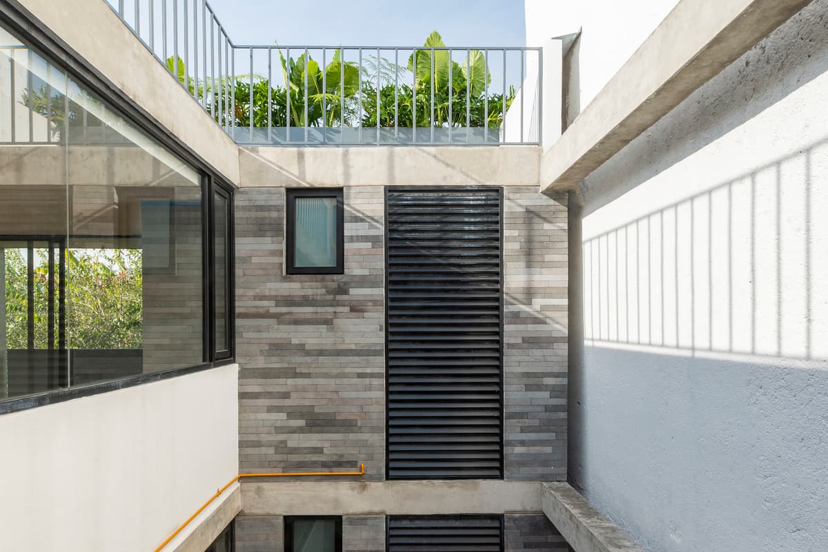 An internal courtyard brings daylight between the apartment levels.