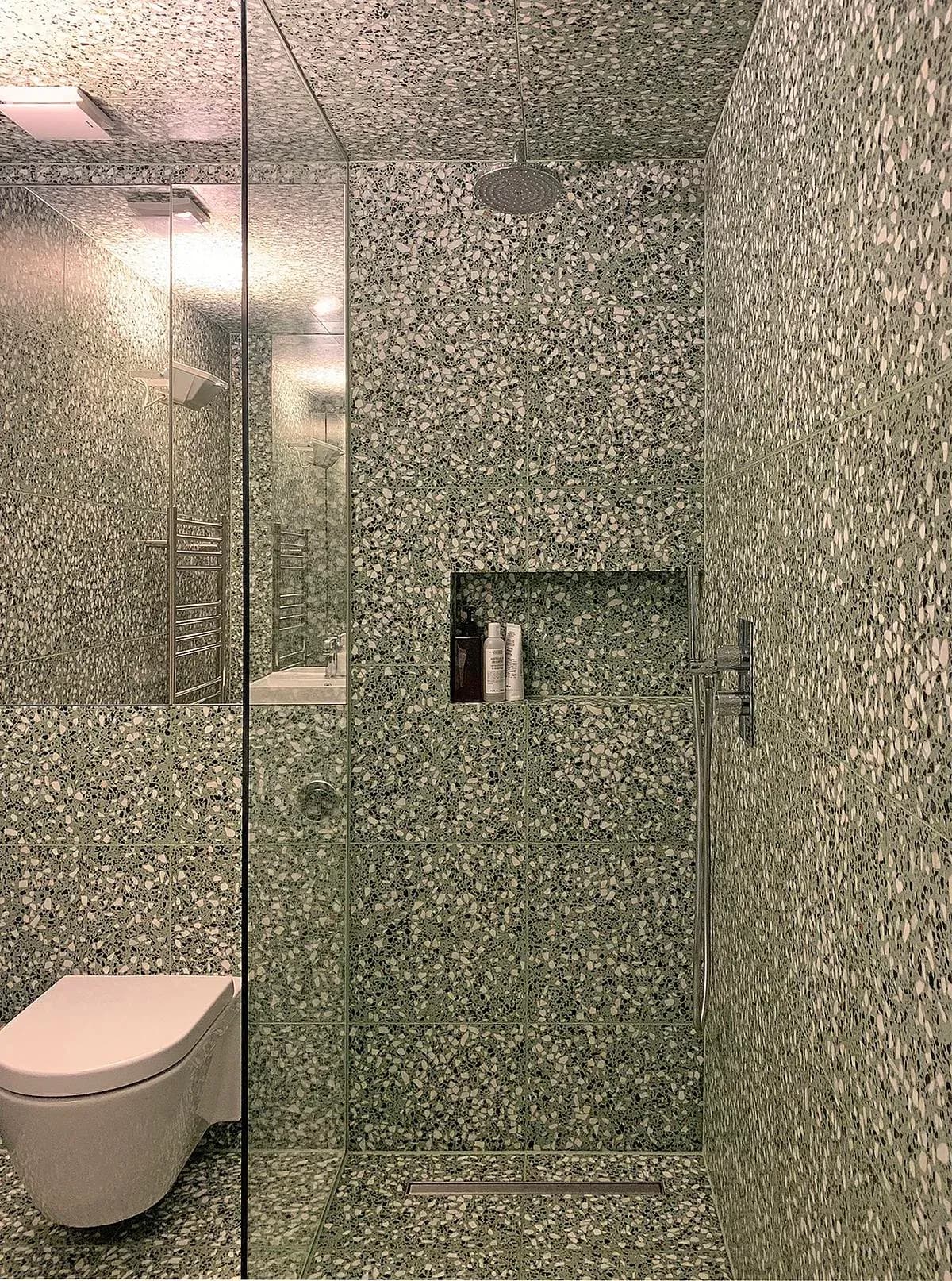 Terrazzo finishes line the shower room.