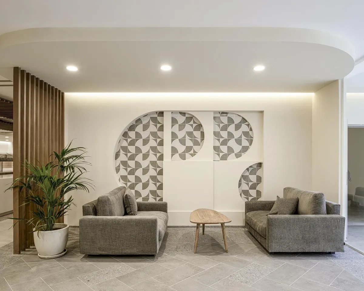 A seating niche is set against circular patterned wall panels.