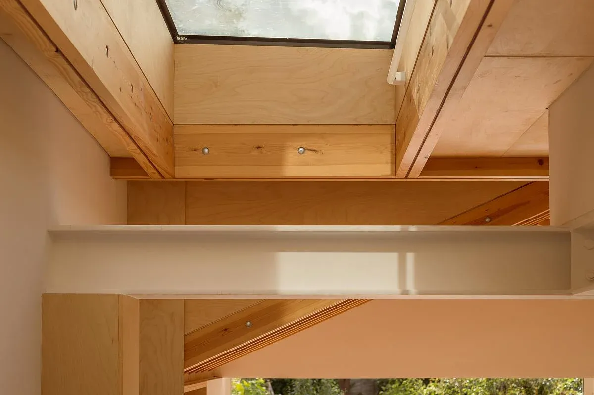 A rooflight and flitch beam reveal the extension’s timber structure.