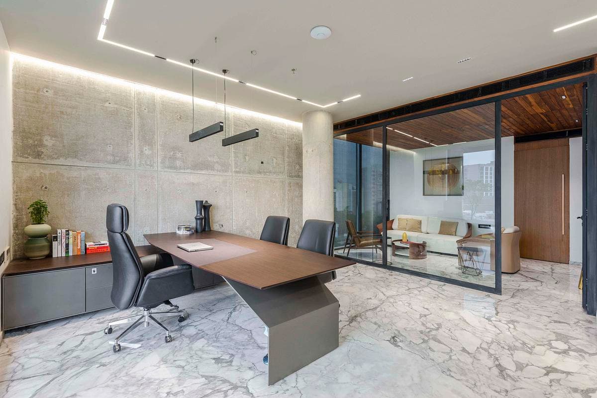 Stone flooring and timber joinery continue into a private office.
