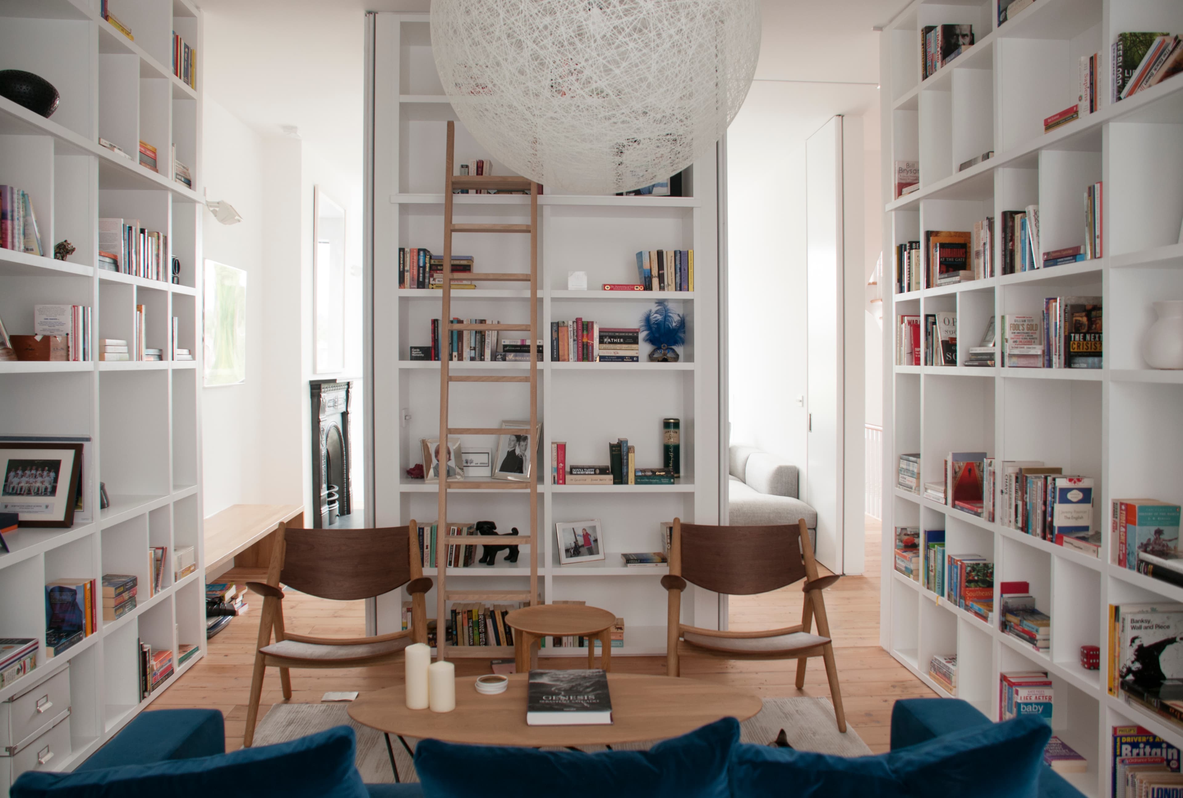 Full-height bookshelves frame the furnished sitting room at Vertical Intersect.
