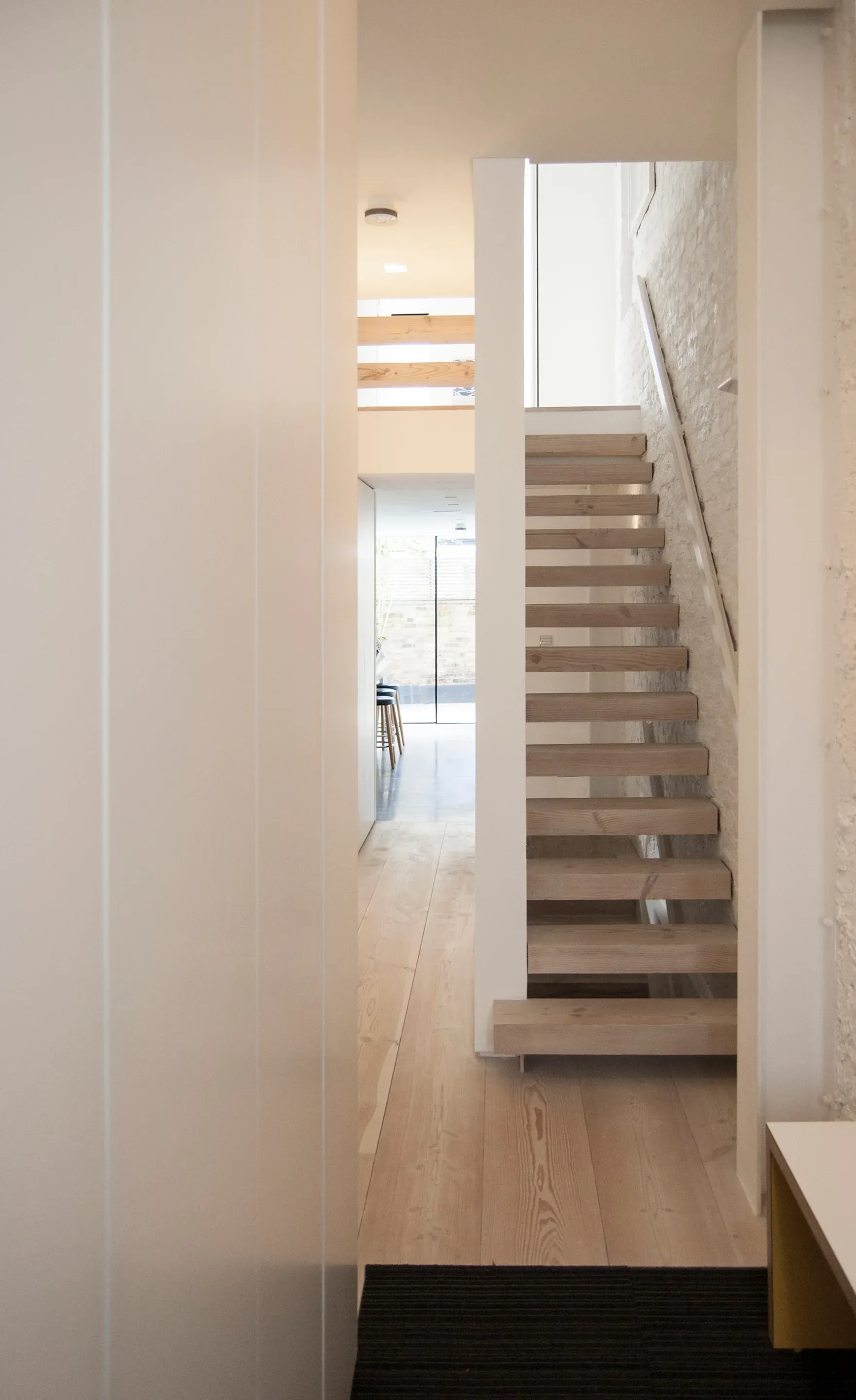 Timber steps form a stack of boxes between the white walls.