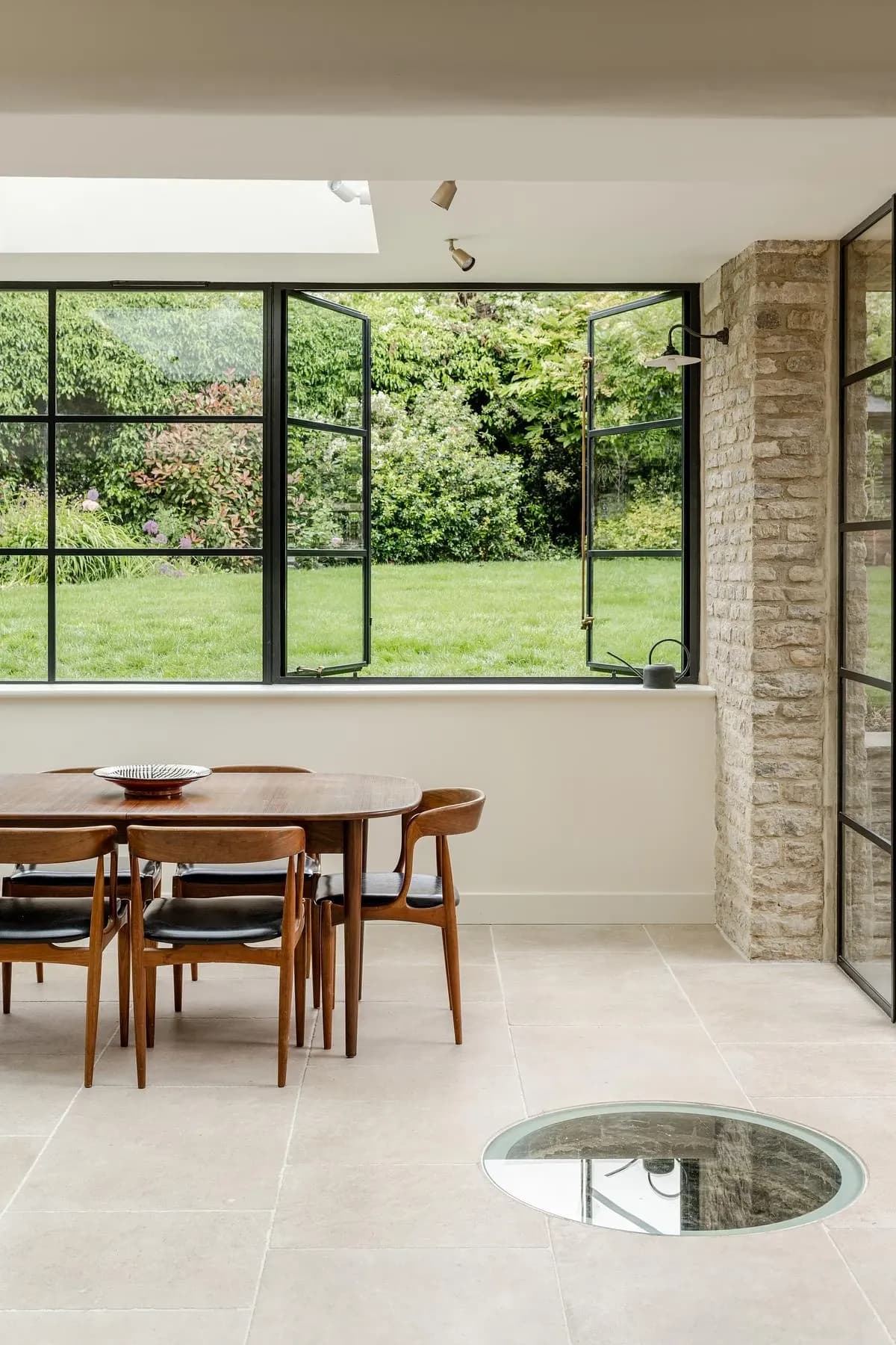 A glass-covered historic well is set into the floor of the new dining space.