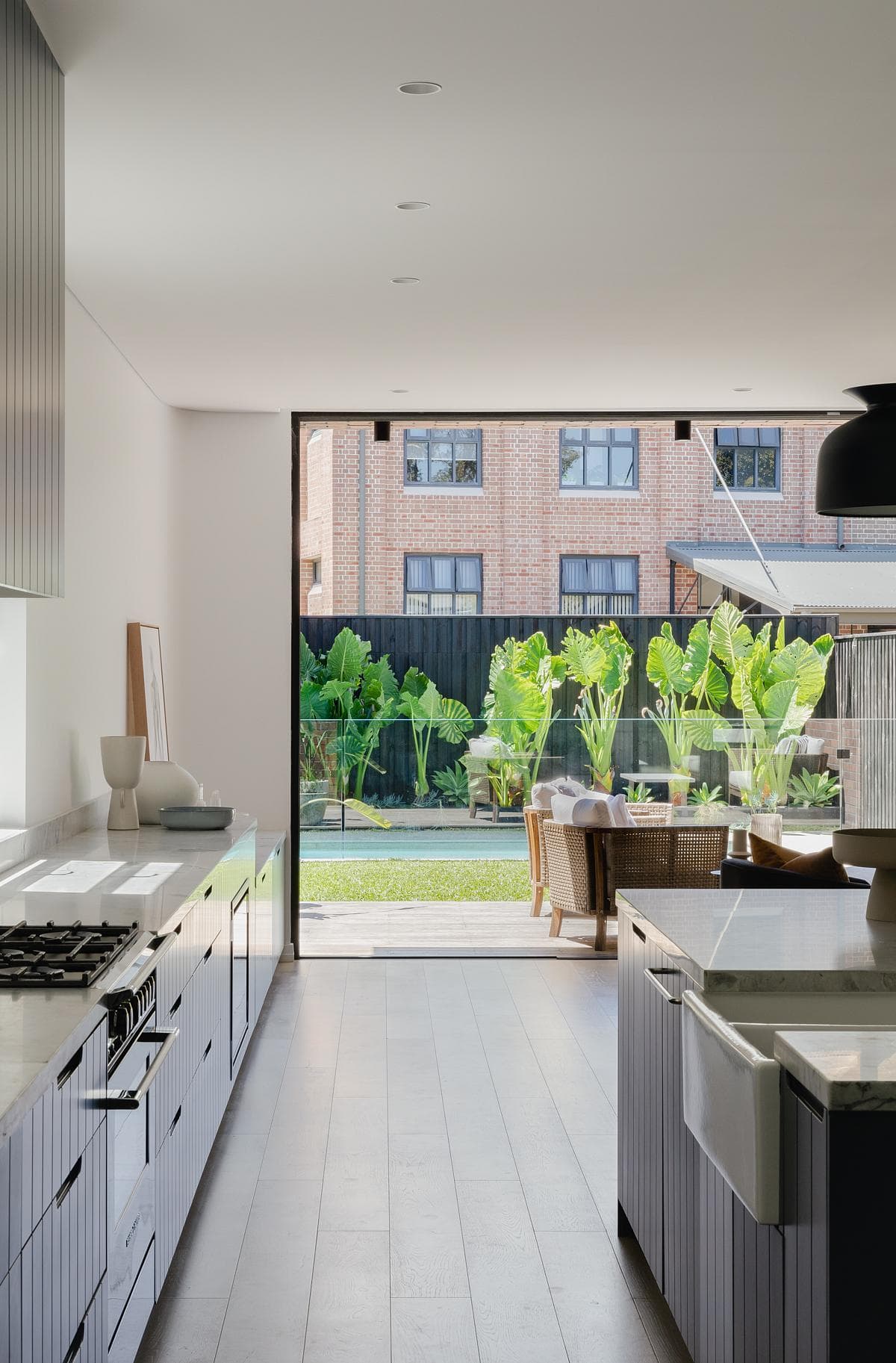 The kitchen looks towards the garden and the neighbouring brick mill building.