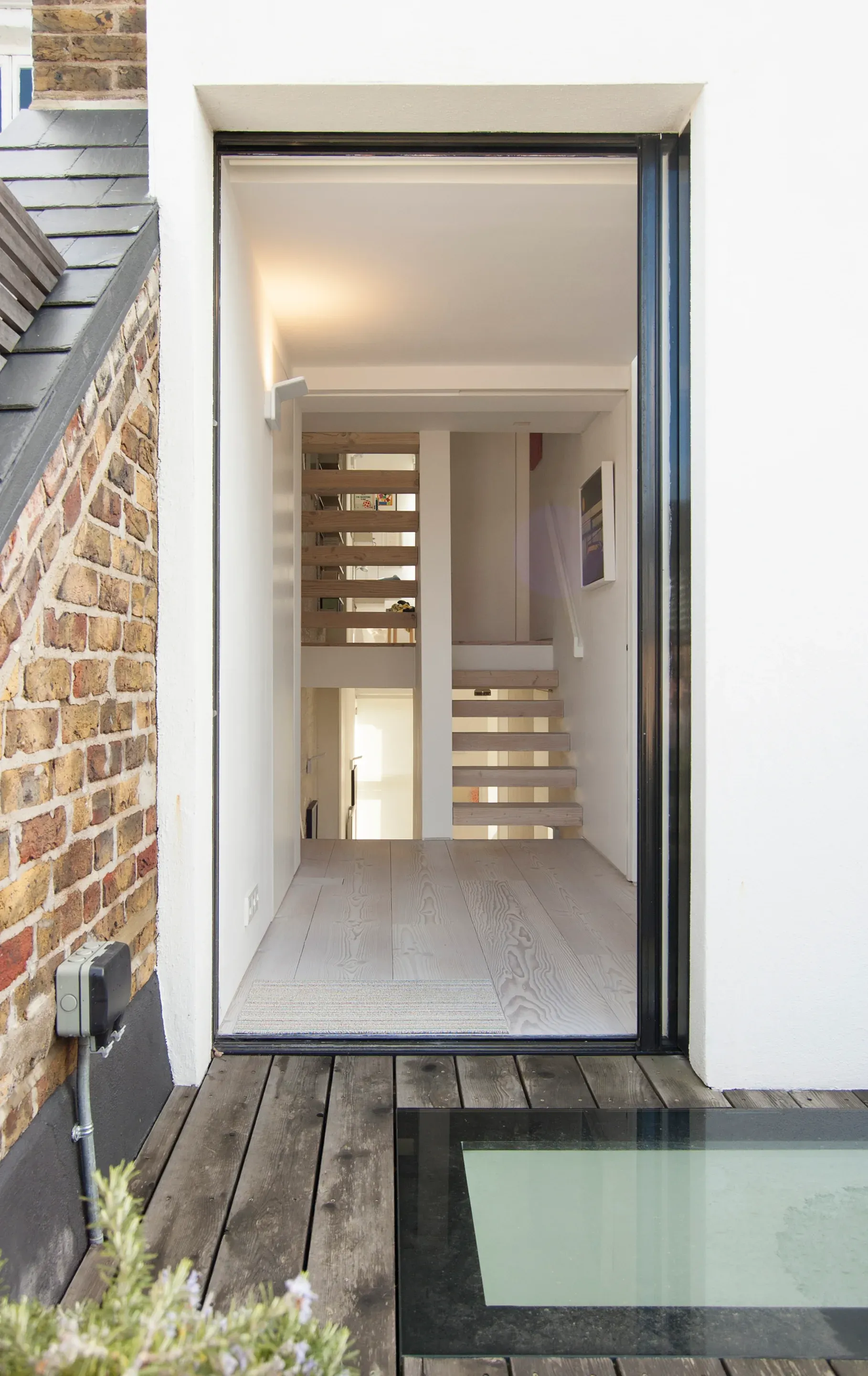Glazing beside the staircase brings daylight into the upper circulation space.