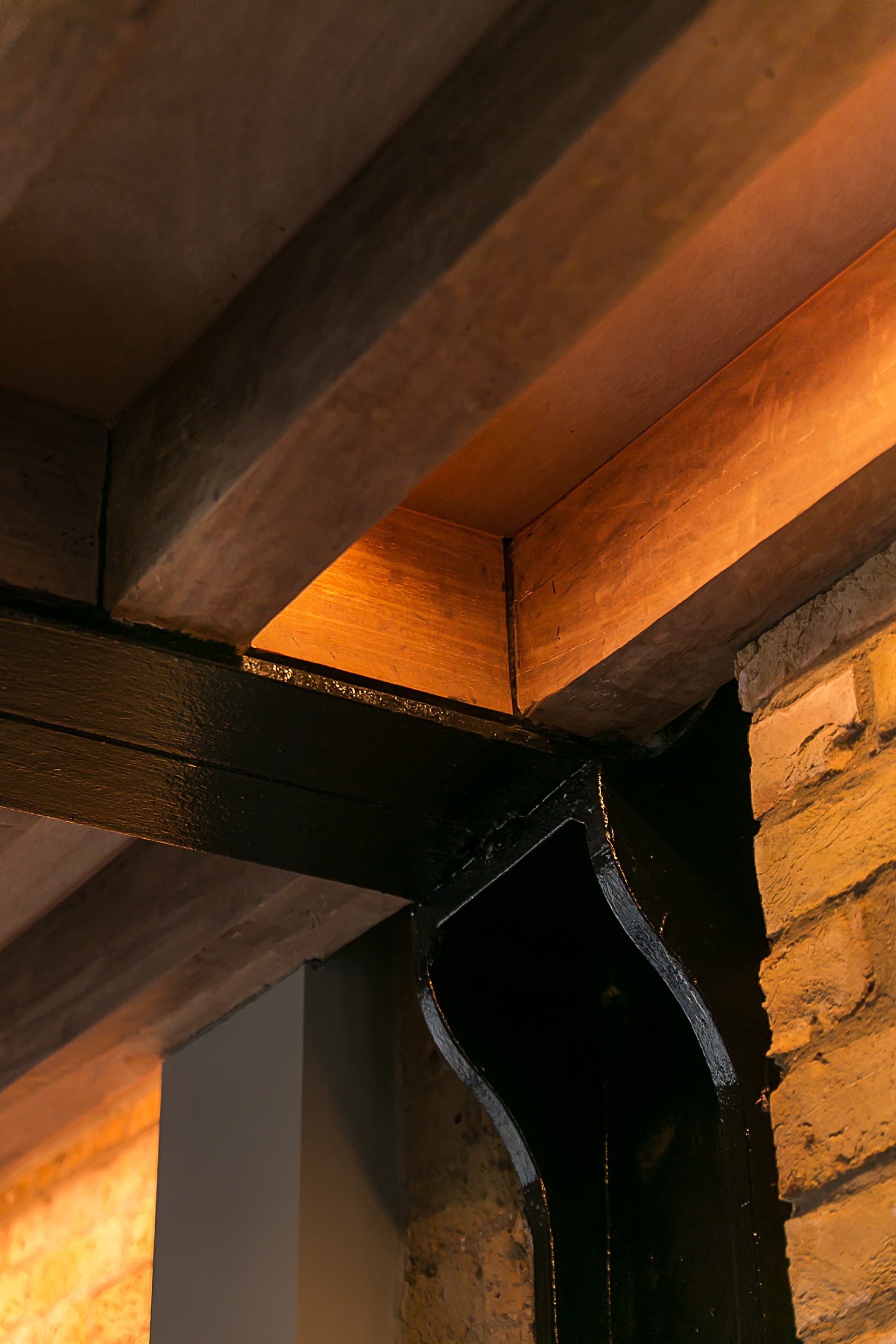 An exposed timber and steel connection reveals the existing structure.